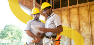 A contractor reviewing a detailed estimate with a construction site, symbolizing cost savings through affordable construction estimating services.